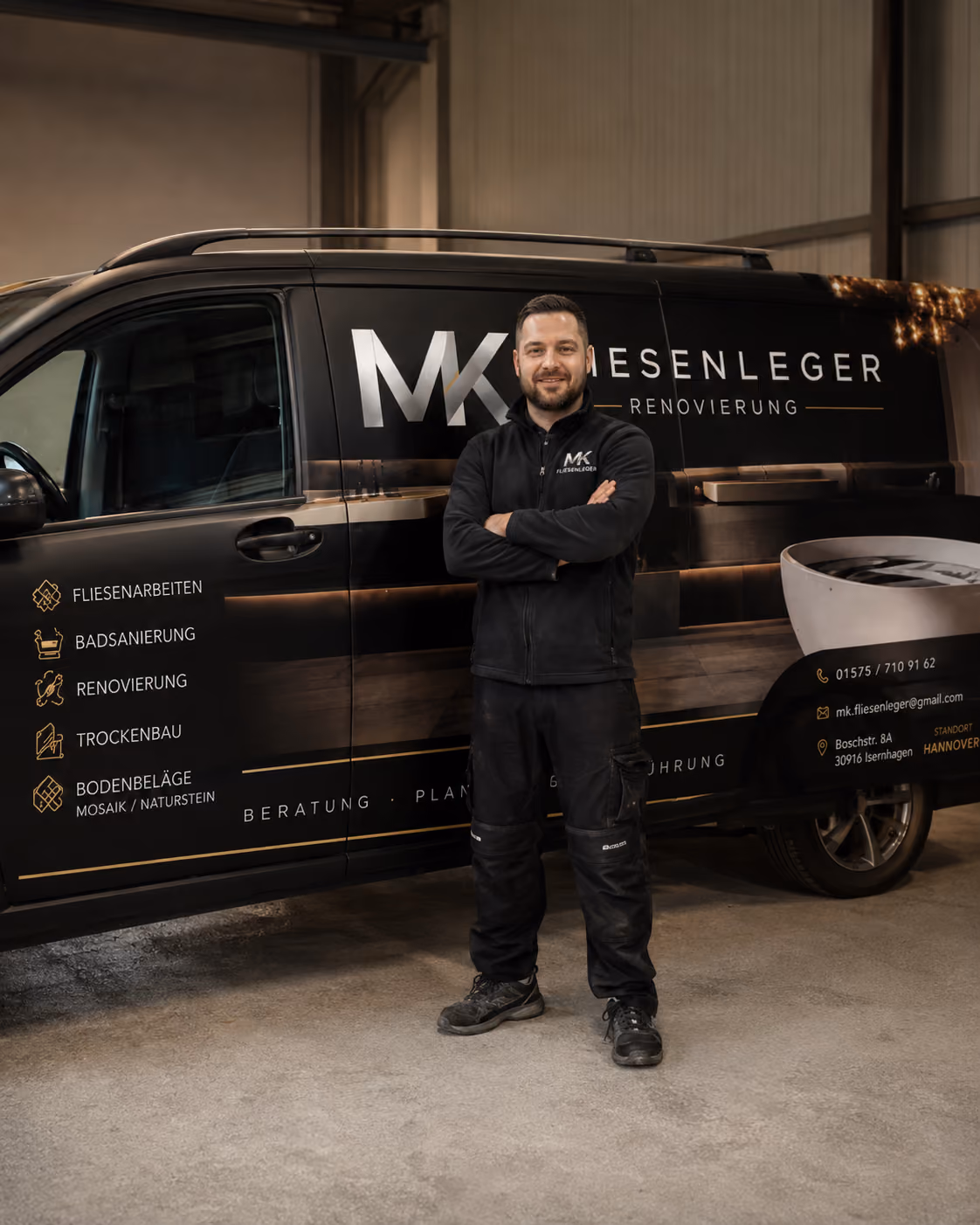 Handwerker in Arbeitskleidung vor dem beschrifteten Firmenfahrzeug von MK Fliesenleger & Renovierung mit den fuenf Leistungsbereichen.